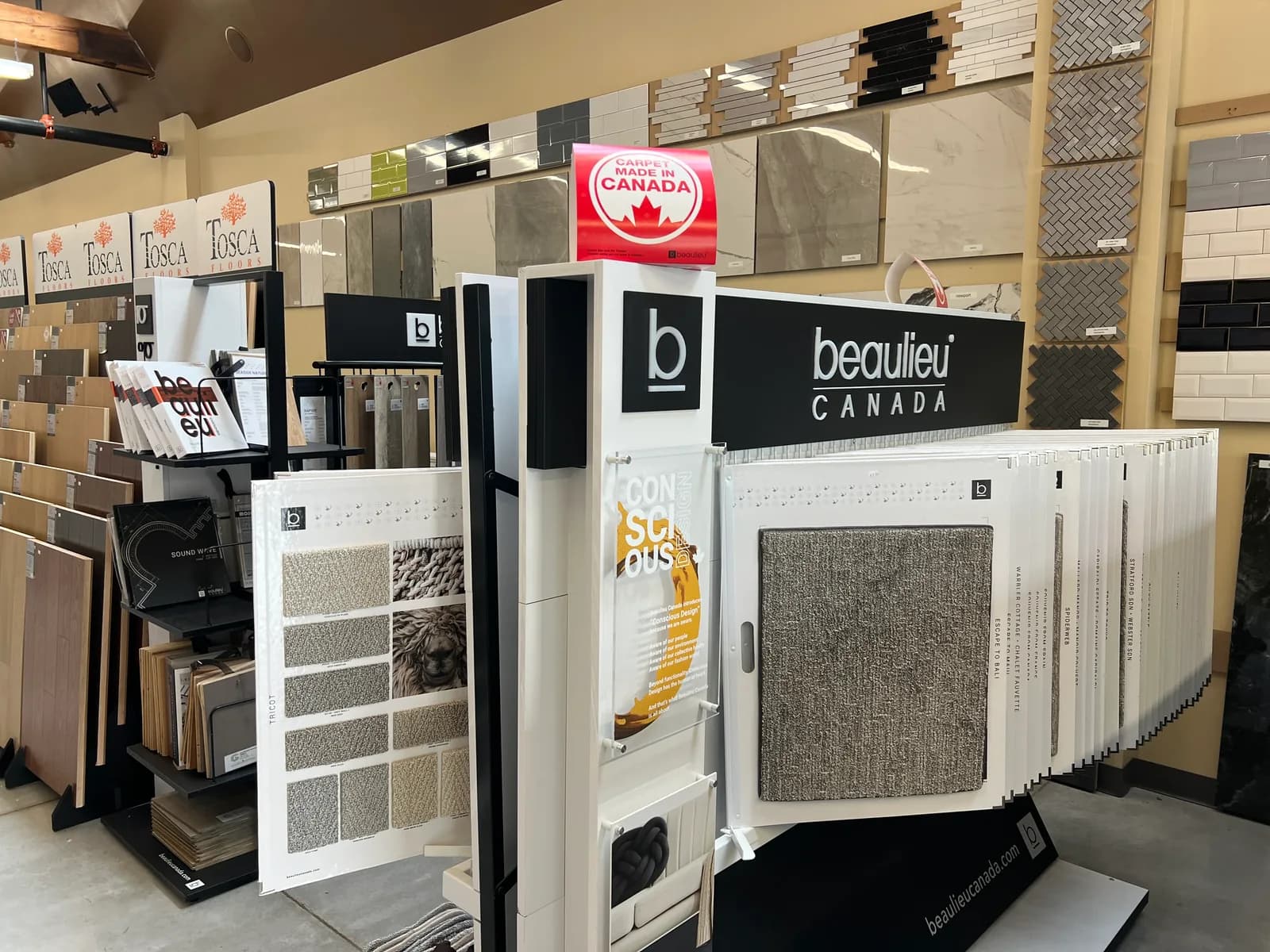 Carpet sample panels and swatch books on a display stand.